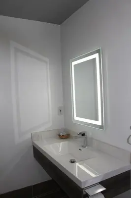 a white bathroom with a sink and a window at ERTH INN by AGA Los Angeles in Los Angeles