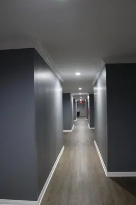 an empty hallway of an office building with a long corridor at ERTH INN by AGA Los Angeles in Los Angeles