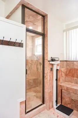 a shower with a glass door in a bathroom at Entire Second Flr - Santa Monica Luxury Roman Villa in Los Angeles