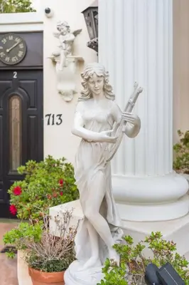 a statue of a woman playing a violin at Entire Second Flr - Santa Monica Luxury Roman Villa in Los Angeles