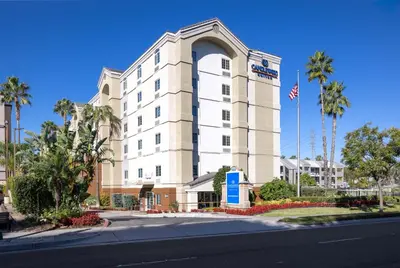 a building with an american flag in front of it at Candlewood Suites Anaheim - Resort Area by IHG in Anaheim