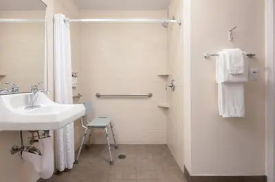 a bathroom with a sink and a shower at Candlewood Suites Anaheim - Resort Area by IHG in Anaheim