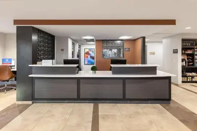 a lobby with a reception desk in a store at Candlewood Suites Anaheim - Resort Area by IHG in Anaheim