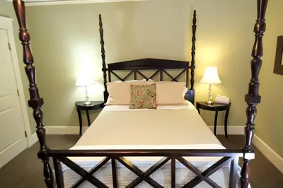 a bedroom with a wooden bed with two lamps at Arroyo Vista Inn in Los Angeles