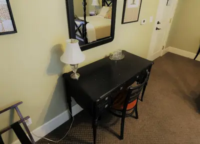 a black desk with a lamp and a mirror at Arroyo Vista Inn in Los Angeles