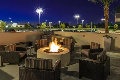 a fire pit on a patio at night at TownePlace Suites by Marriott Ontario Chino Hills in Chino Hills
