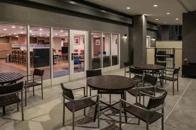 a group of tables and chairs in a restaurant at TownePlace Suites by Marriott Ontario Chino Hills in Chino Hills