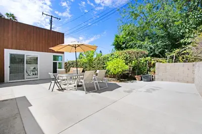 a patio with a table and an umbrella at Beautiful House Fantastic view in Azusa in Azusa