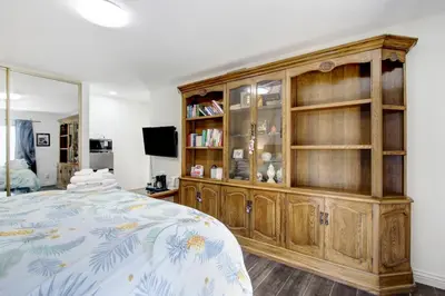 a bedroom with a wooden hutch and a bed at Beautiful House Fantastic view in Azusa in Azusa