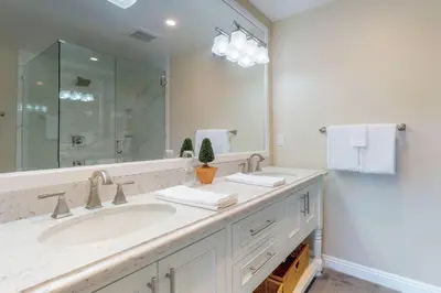 a bathroom with a sink and a large mirror at Mountain Top Chalet in Lake Arrowhead