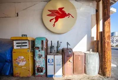 a group of old rusty appliances sitting next to a wall at Route 66 Motel in Barstow