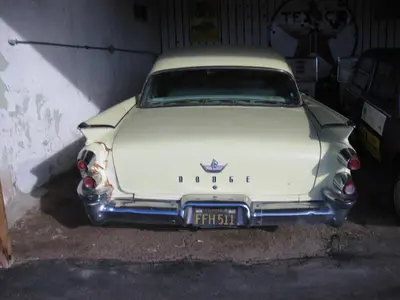 a white car is parked in a garage at Route 66 Motel in Barstow