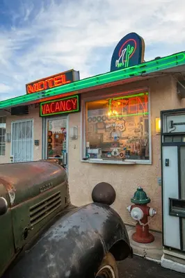 an old car parked in front of a marmite pharmacy at Route 66 Motel in Barstow