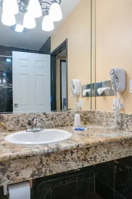 a bathroom with a sink and a mirror at Redondo Beach Inn-LAX in Gardena
