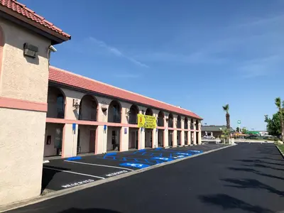 an empty parking lot in front of a building at National 9 Inns in Buttonwillow