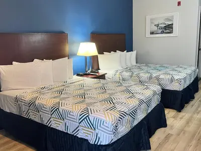 two beds sitting next to each other in a hotel room at Baymont by Wyndham Ridgecrest in Ridgecrest
