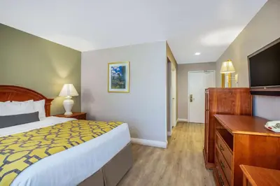 a hotel room with a bed and a flat screen tv at Baymont by Wyndham Tehachapi in Tehachapi