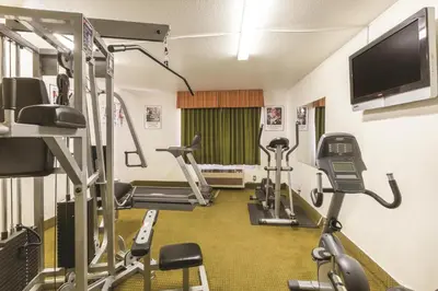 a gym with several tread machines and a flat screen tv at Baymont by Wyndham Tehachapi in Tehachapi