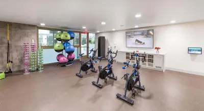 a gym with cardio exercise bikes in a room at Modern Apartment Rentals in Los Angeles