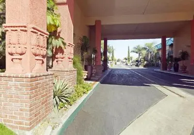 a brick building with a street in front of it at Americas Best Value Inn & Suites - Fontana in Fontana
