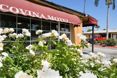 a restaurant with white flowers in front of it at Covina Motel in West Covina