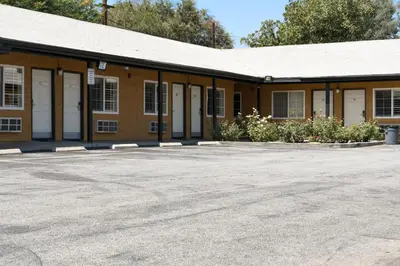 an empty parking lot in front of a building at Covina Motel in West Covina