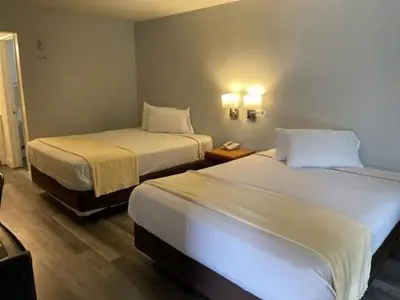 a hotel room with two beds and a phone at Premier Inns Thousand Oaks in Thousand Oaks