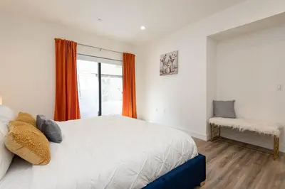 a bedroom with a large bed and a window at Regency Modern Apartments in Glendale