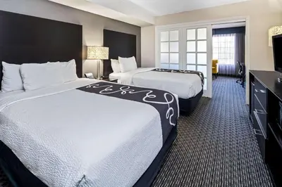 a hotel room with two beds and a television at La Quinta by Wyndham Anaheim in Anaheim