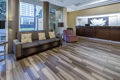 a lobby with a couch and a waiting room at La Quinta by Wyndham Anaheim in Anaheim