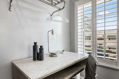 a white room with a table and a window at Lumea by the Sea Long Beach Convention Center in Long Beach