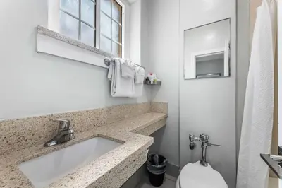 a bathroom with a sink and a toilet at Lumea by the Sea Long Beach Convention Center in Long Beach