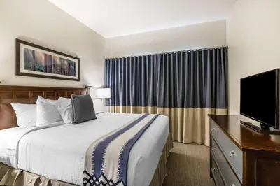 a hotel room with a bed and a flat screen tv at Bluegreen Vacations Big Bear Village, an Ascend Collection Resort in Big Bear Lake