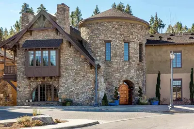 a large brick house with a turret at Bluegreen Vacations Big Bear Village, an Ascend Collection Resort in Big Bear Lake