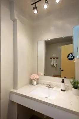 a bathroom with a sink and a large mirror at Anchor Pointe Inn in Wilmington
