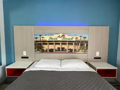 a bedroom with a bed with a sign above it at Lincoln Motel - Los Angeles, Hollywood Area in Pasadena
