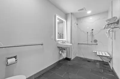 a bathroom with a sink and a toilet and a shower at Travelodge by Wyndham Fairplex Pomona in Pomona