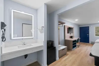 a bathroom with a sink and a mirror at Travelodge by Wyndham Fairplex Pomona in Pomona