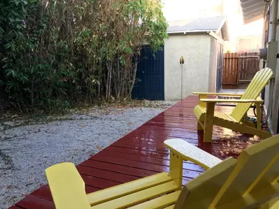 two yellow chairs and a table on a deck at Long Beach House in Long Beach