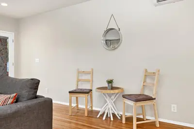 a living room with two chairs and a mirror on the wall at Long Beach House in Long Beach