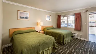 a hotel room with two beds and a window at Harbor Motel in Anaheim