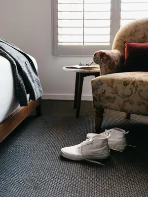 a room with a chair and a pair of shoes on the floor at Palihotel Culver City in Los Angeles