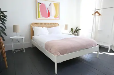 a bedroom with a bed with a pink blanket at The Burlington in Los Angeles