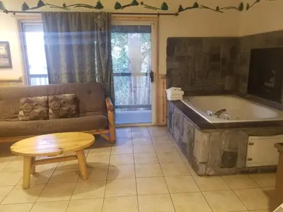 a living room with a couch and a bath tub at Fireside Lodge in Big Bear Lake