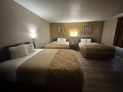 a hotel room with two beds and two lamps at Budget Inn On Historic Route 66, Barstow in Barstow