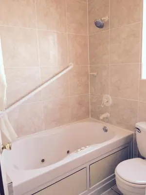 a bathroom with a tub and a toilet at Budget Inn On Historic Route 66, Barstow in Barstow