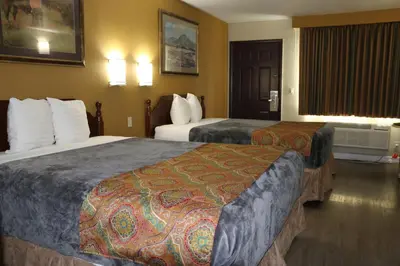 a hotel room with two beds and a window at Budget Inn On Historic Route 66, Barstow in Barstow