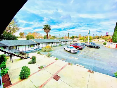 an aerial view of a building with cars parked in a parking lot at Casa Blanca Inn - Whittier, Los Angeles in Whittier