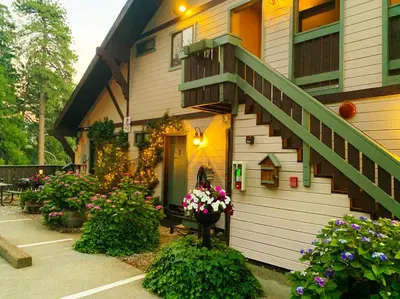 a house with flowers and a staircase on it at The North Shore Inn in Crestline