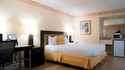 a hotel room with a large bed and a desk at Motel 6 - Anaheim Hills, CA in Anaheim